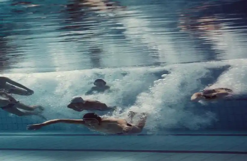 Picture from "The Plague" of boys diving and swimming in a pool.
