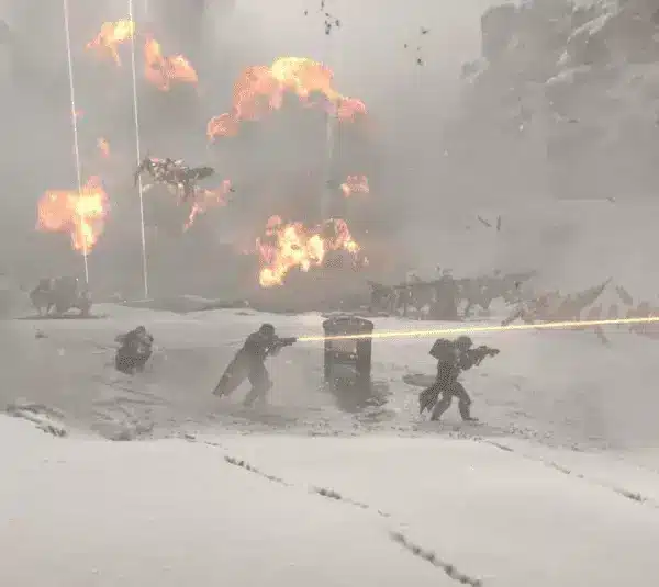 Helldivers 2 player characters in a snow-covered battlefield with five soldiers firing weapons amidst explosions. Bright orange blasts illuminate the snowy terrain, creating a tense atmosphere.