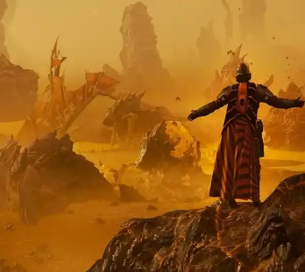 Helldivers 2 player character in Oshaune Campaign Cape stands on rocky terrain with outstretched arms, facing a dramatic alien landscape bathed in golden light.