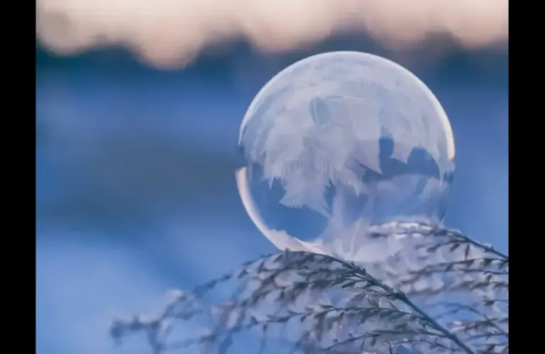 Winter solstice, frozen sphere with winter background