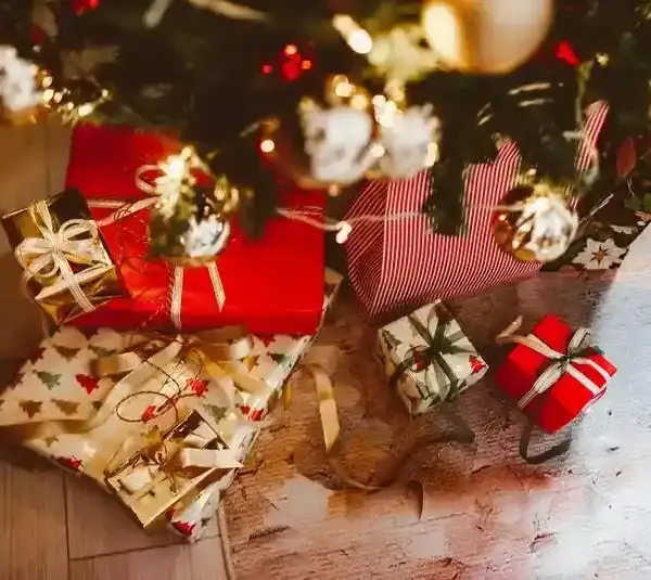 Video Games, as a Christmas Tradition, wrapped in red and festive paper, are placed under a decorated tree.