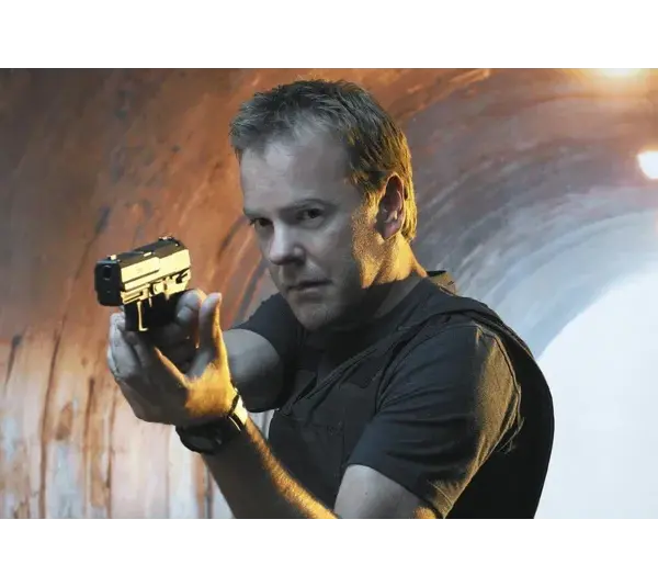 Kiefer Sutherland as Jack Bauer aiming a pistol, standing in a dimly lit tunnel
