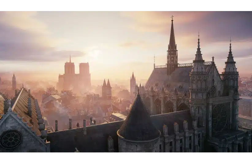 Aerial view of a historic European city skyline at sunrise, with intricate gothic architecture, pointed towers, and a warm, serene glow from the sun. Assassin's Creed: Unity, Courtesy of Ubisoft.