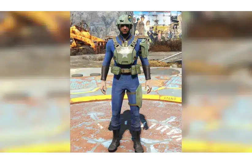 A Fallout 4 character in a blue and yellow futuristic jumpsuit stands on a platform, wearing green armor and helmet, against a post-apocalyptic backdrop with machinery.