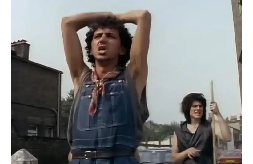 Dexys Midnight Runners perform "Come On Eileen" on a street corner in a music video for the song.