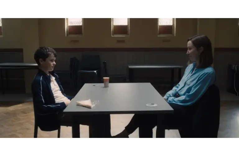 Eric Doherty, pictured with co-star Owen Cooper in a scene at a table in the Netflix series "Adolescence," won Best Performance by a Female Actor in a Supporting Role on Television at the 2026 Golden Globes.