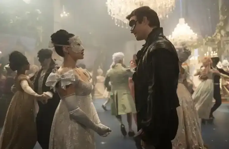 TV couples in elegant, vintage attire and masks stand facing each other at a lavish masquerade ball. Chandelier-lit ambiance, other couples dance. Romantic tone.