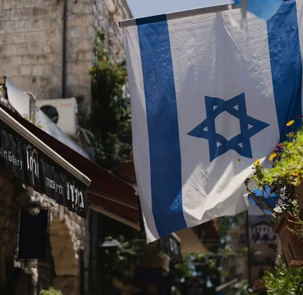 Image of the flag of Israel flying on a short pole above the entrance to a building, Genesis, Old Testament