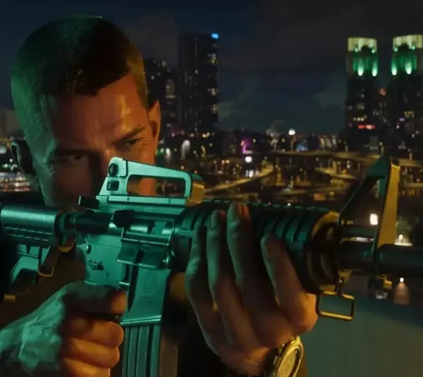 Character from Rockstar's GTA 6 holding a rifle on a rooftop at night, with a city skyline illuminated by colorful lights in the background, conveying tension and focus.