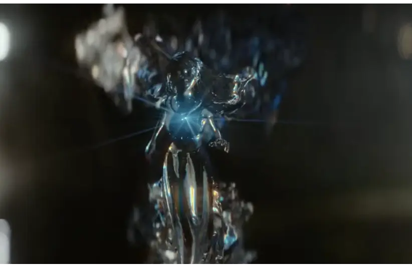 A luminous, abstract figure with a reflective, metallic surface appears in a dark background. It conveys a sense of mystery and ethereal energy. It is coming to grant a wish in "Starbright."