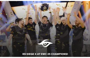 R6 Siege X at EWC 25, celebrating a championship victory on stage with arms raised, surrounded by confetti. Esports events