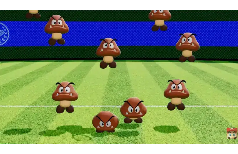 Image of multiple cartoon-like brown Goomba characters with angry expressions on a striped green field and a blue background. Playful and energetic tone.