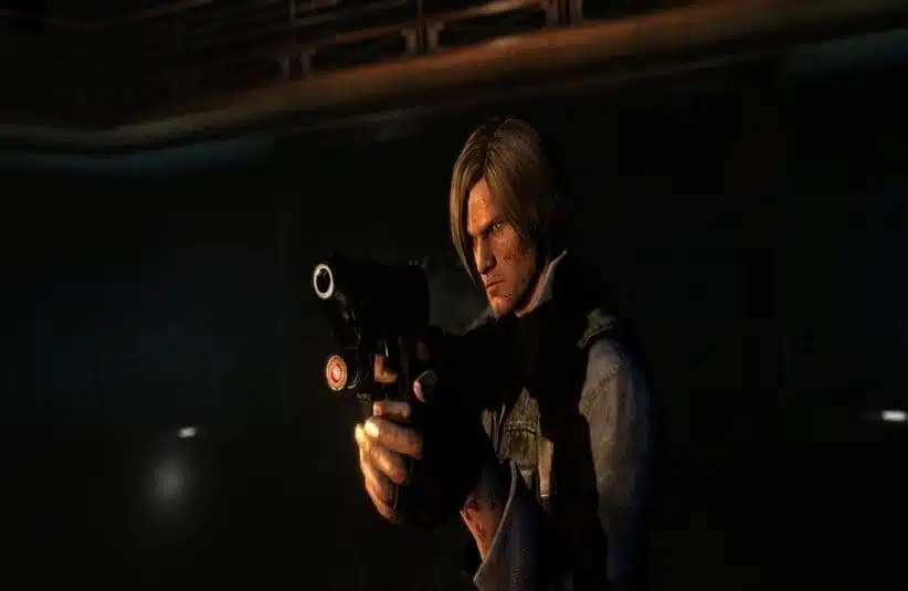 Resident Evil's Leon Kennedy aims a handgun in a dimly lit, tense setting. The spotlight highlights his focused expression and tactical gear.