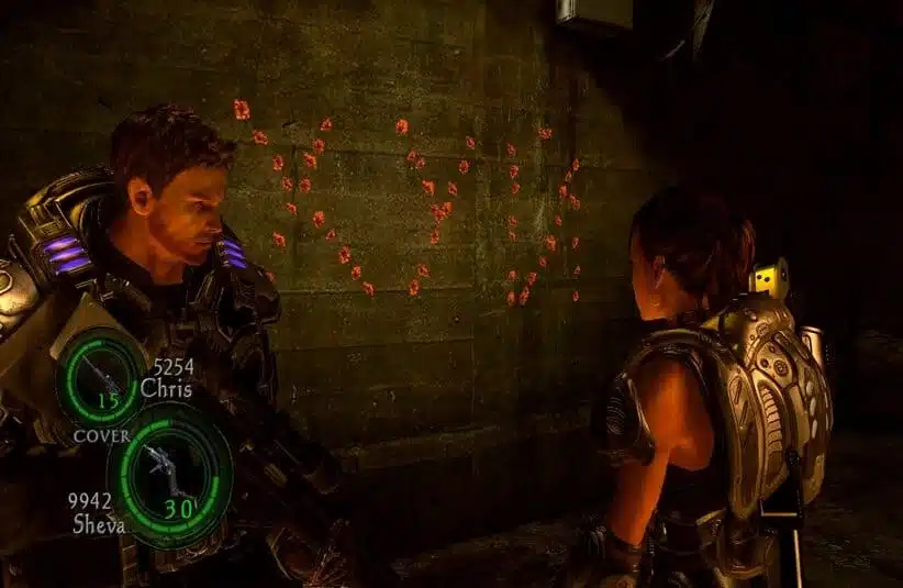 Two armored characters in Resident Evil 5 stand in a dimly lit, industrial room. Red markings form a heart on the wall behind them, suggesting a moment of unexpected romance.