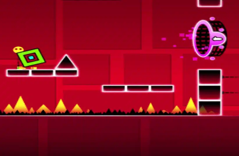 A vibrant red game scene in Geometry Dash features a green square character tilting on a platform near a black triangle, with spikes below and a glowing portal ahead.