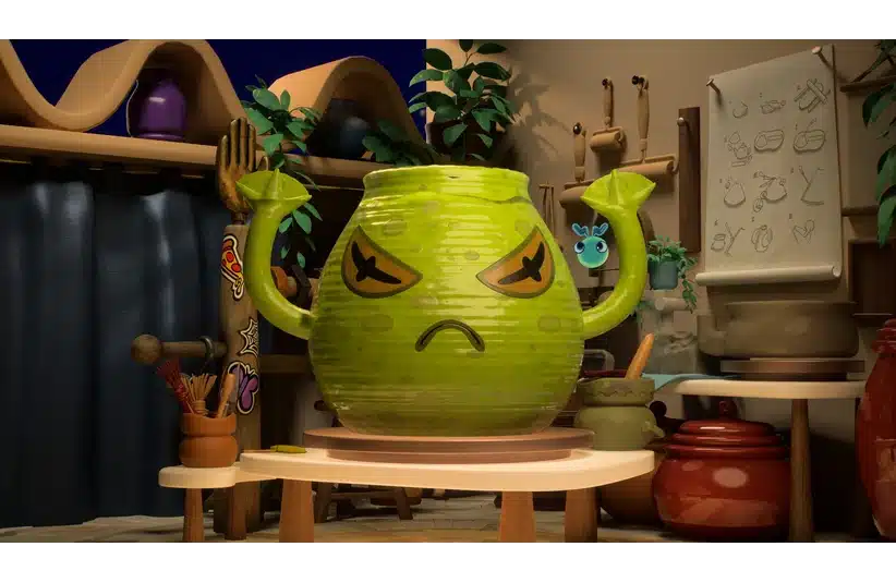 A green, animated pot in Kiln with angry eyes and a frowning face stands on a table. Its handles resemble arms. The room is filled with pottery tools and pots.