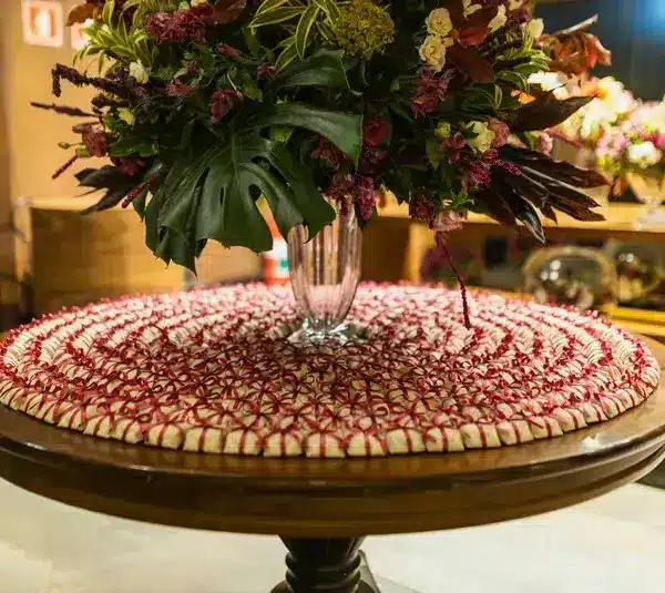 a beautiful valentine centerpiece on a table with a table mat