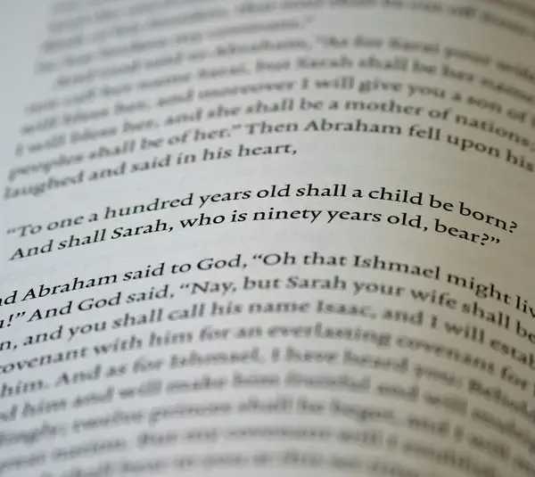 In daily devotion, a Bible is open to a passage in Genesis.