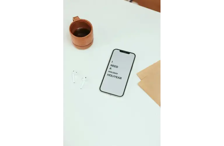 Smartphone displays "I need a holiday" pointing to a digital detox.