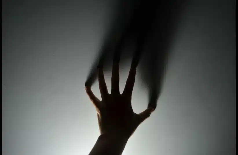 In daily devotion, a man's hand is shown on a wall.