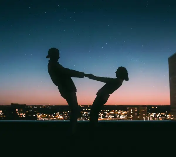 slow dating couple dancing on a rooftop