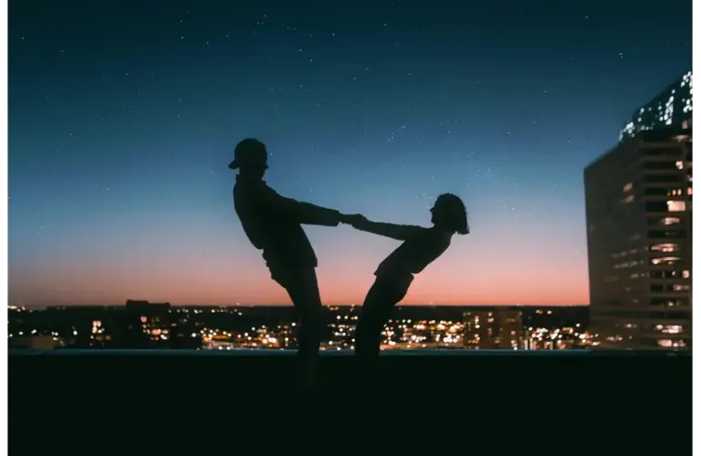 slow dating couple dancing on a rooftop