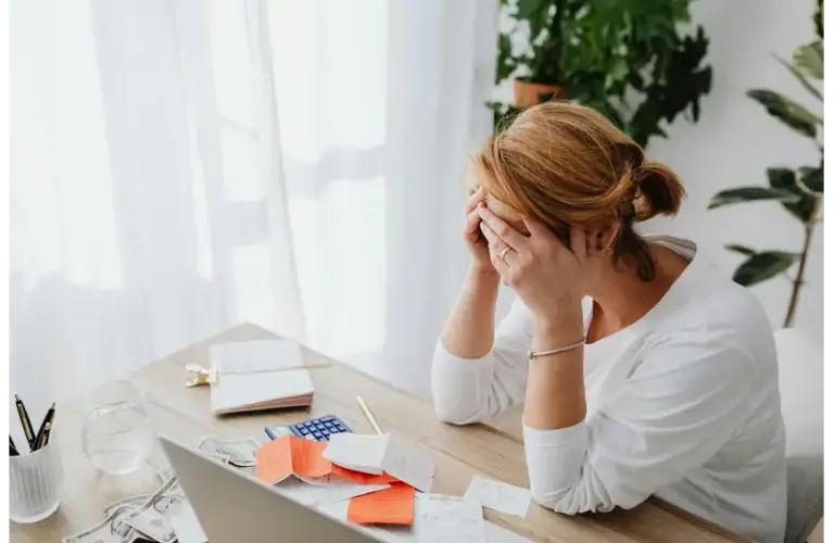 women in financial stress on her office table