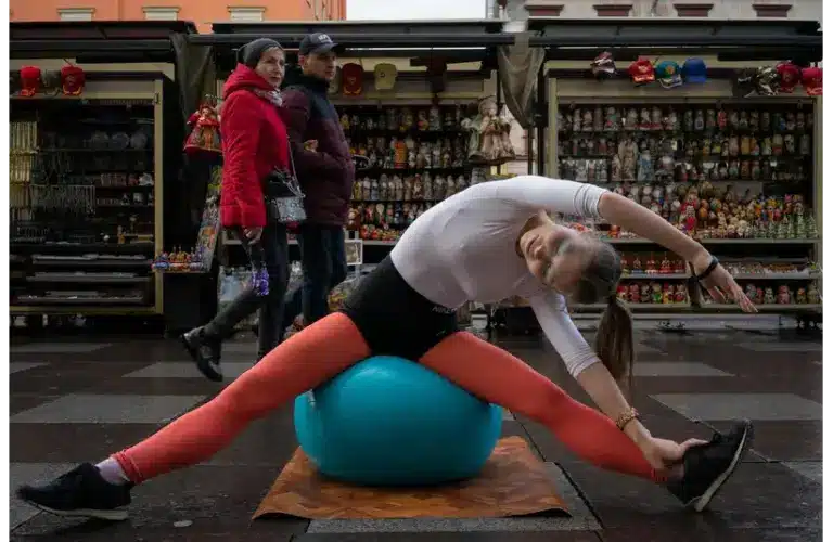 Image of a woman sitting on blue exercise ball
