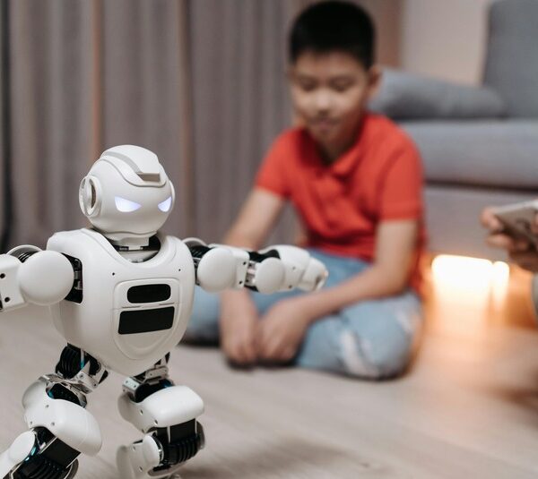A young boy and a robot at CES, where smart home products are being unveiled.