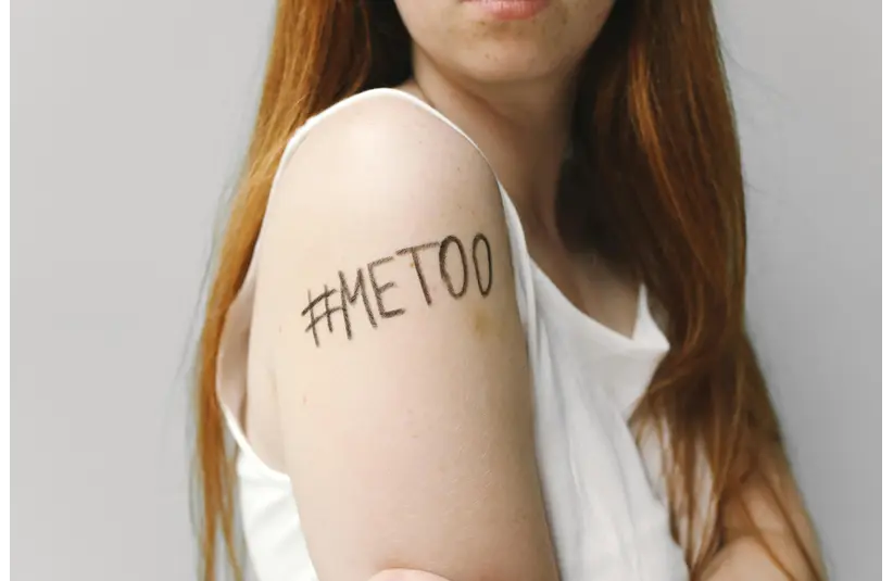 A woman showing her arm with the slogan "#METOO"