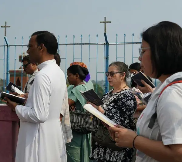 For the week of prayer a group of people are praying and reciting short readings along with their priest.