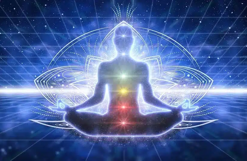 Image of A glowing figure meditates in a lotus position, with colorful chakras aligned, set against a cosmic, grid-like backdrop, evoking serenity, confidence and spiritual energy to represent the solar plexus chakra