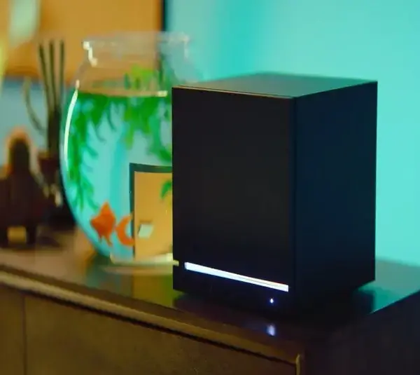 The Steam Machine sitting next to a fishbowl.