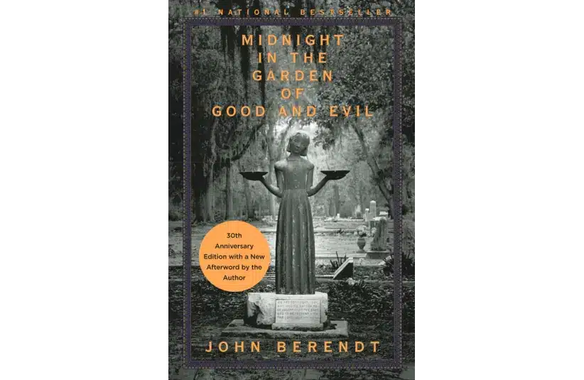 Cover of "Midnight in the Garden of Good and Evil" by John Berendt. Features a statue holding bowls, surrounded by a spooky cemetery, with a 30th-anniversary sticker.