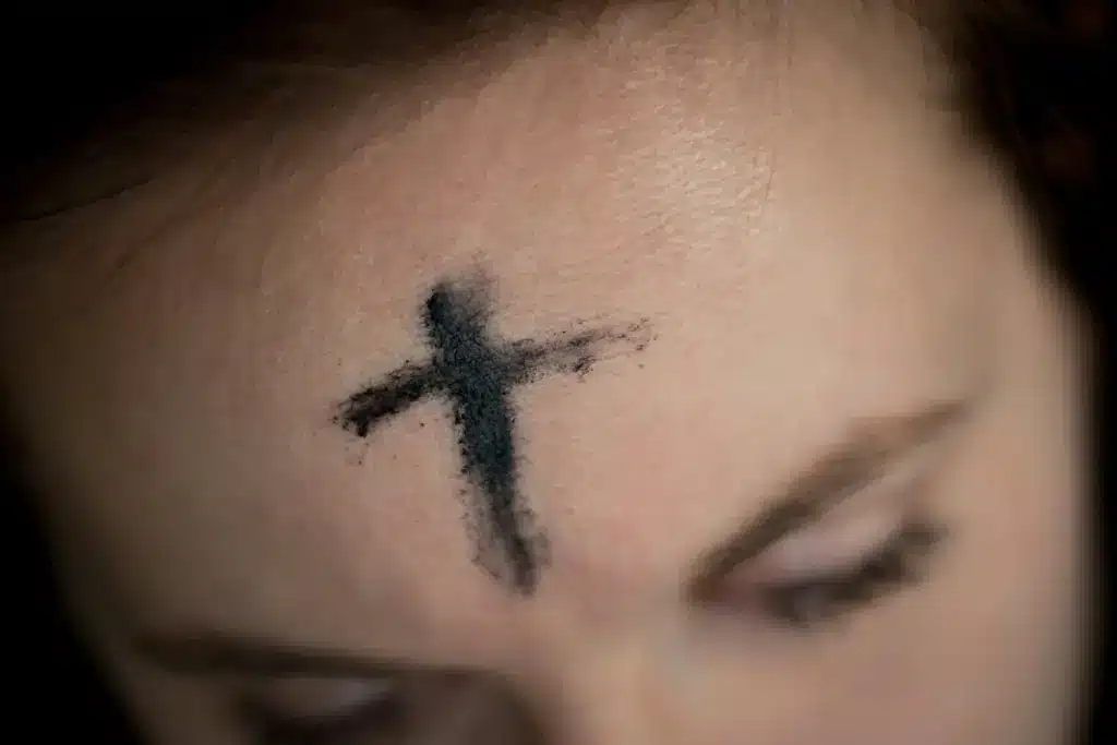 A person with ashes forming a cross on their forehead for Ash Wednesday