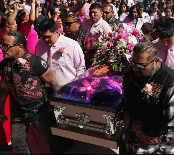 Pallbearers bring in the casket carrying Emily Pike.