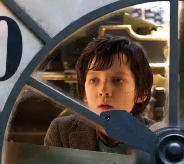 Best steampunk films - “Hugo” - image of Asa Butterfield examining an automaton clock