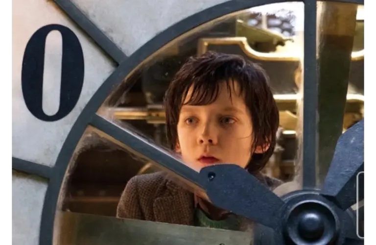 Best steampunk films - “Hugo” - image of Asa Butterfield examining an automaton clock