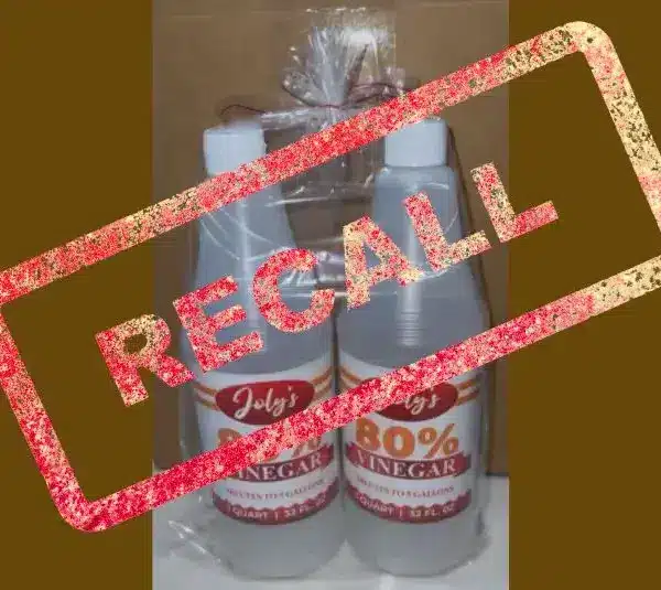 Two bottles labeled "80% Vinegar" with a bold red "Recall" stamp overlay. The tone is urgent, highlighting a safety concern.