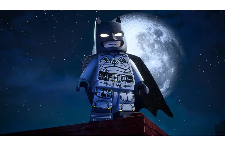 LEGO Batman stands heroically on a rooftop, set against a large, bright full moon and starry night sky, conveying a sense of vigilance and adventure.