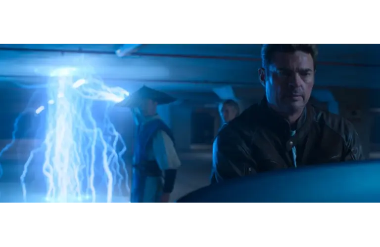 Three people, in Mortal Kombat 2, stand in a dimly lit room. Blue lightning arcs from the ceiling. The mood is tense, with focus on a man in a leather jacket in the foreground.