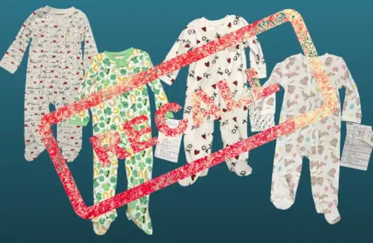 Four children's pajamas with various colorful patterns on a teal background are overlaid with a bold red "RECALL" stamp, indicating a product recall.