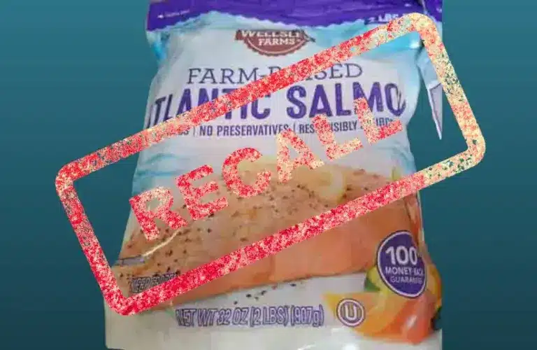 Package of farm-raised Atlantic salmon with "Recall" in bold red letters across it. Emotional tone is urgent, suggesting a health risk.