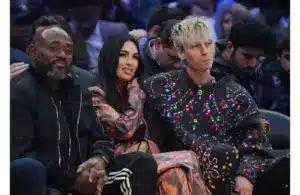Feb 20, 2022; Cleveland, Ohio, USA; Recording artist Machine Gun Kelly (right) with wife Megan Fox (center) during the 2022 NBA All-Star Game at Rocket Mortgage FieldHouse. Fox and MGK are one of the least liked celebrity couples. Mandatory Credit: Kyle Terada-Imagn Images