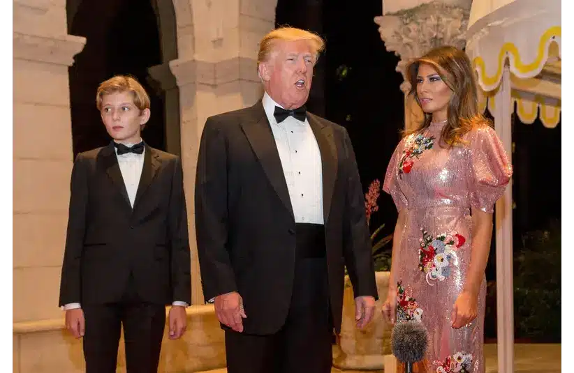 Barron Trump, left, along with his father President Donald Trump and First Lady Melania Trump walk the red carpet to the ballroom for the Mar-a-Lago New Year's Eve Gala in Palm Beach on Dec. 31, 2017. © Greg Lovett / USA TODAY NETWORK via Imagn Images