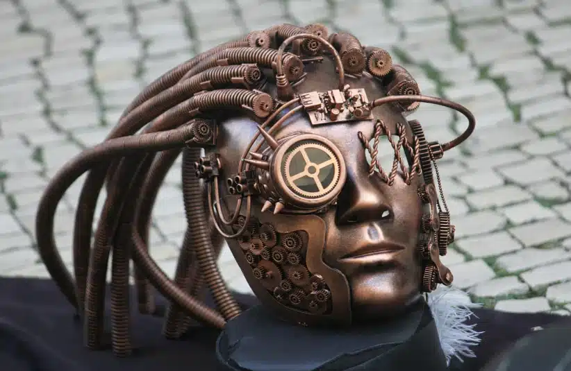 A steampunk sculpture of a human head in a collection of copper gears, wires and pipes.