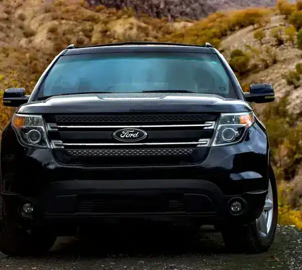 Black Ford Explorer from the front parked on the side of a road with hills behind it. Part of Feb 2026 recall.
