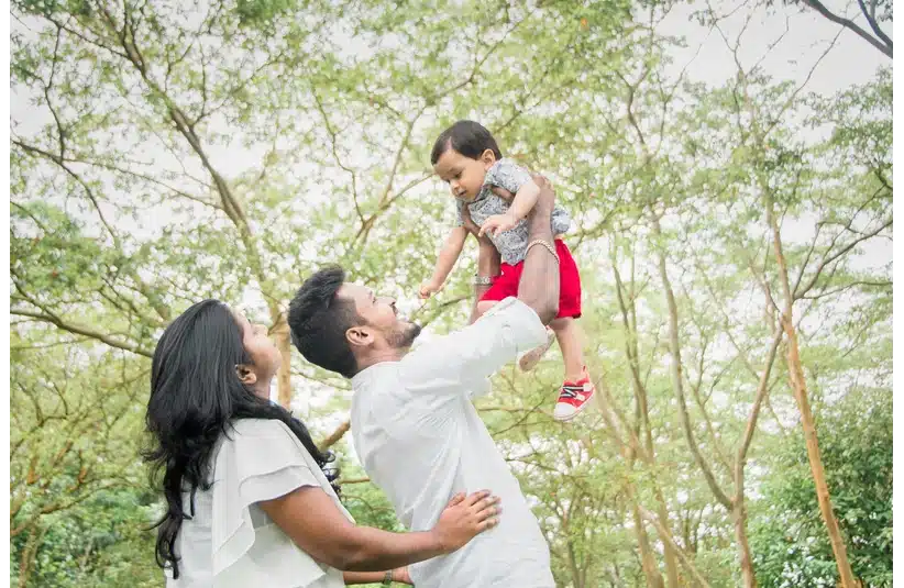 A couple holding their baby