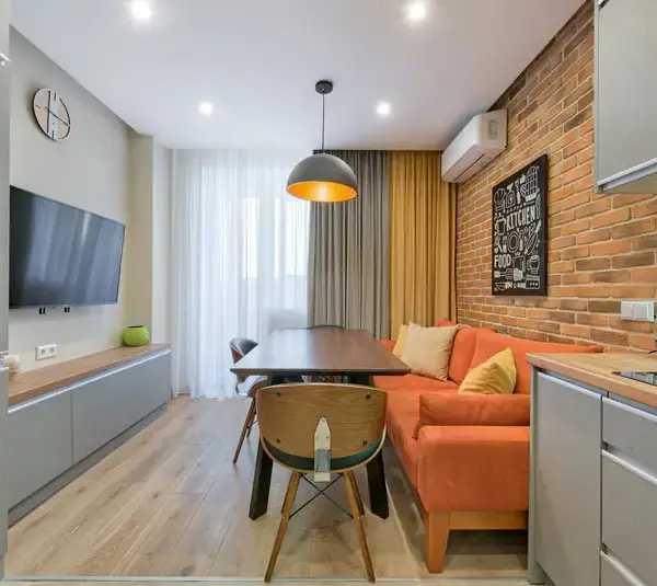 a small living area beautifully decored with sofas and curtains.