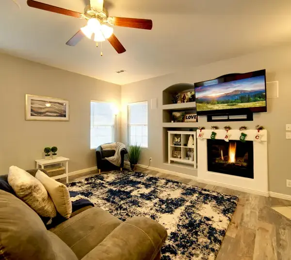 a beautiful living area with a simple and decent mantel decor